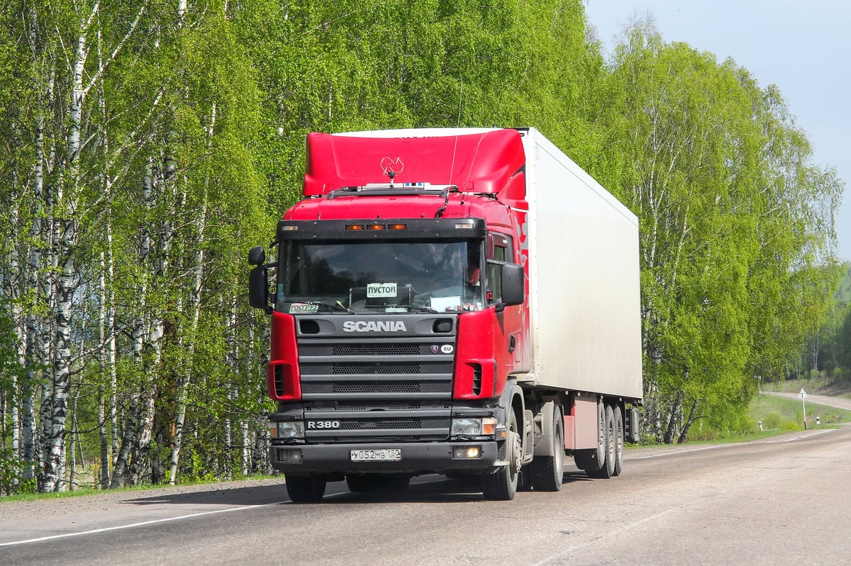 Red Scania R380 cab-over truck, brand new modern European truck on the road